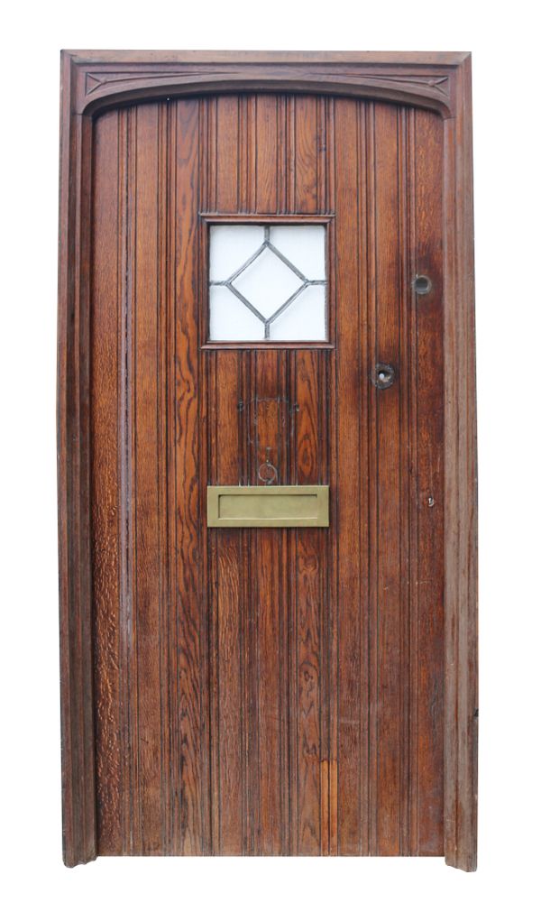 A Reclaimed Arched Oak Exterior Door with Frame