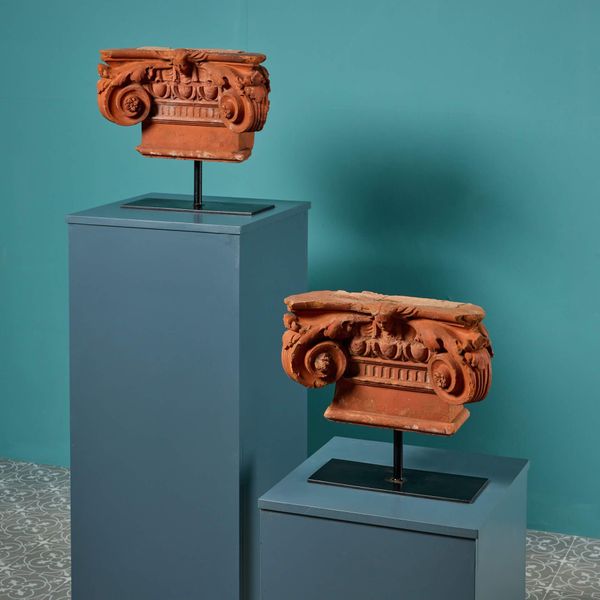 Pair of Decorative Terracotta Ionic Capitals on Stands